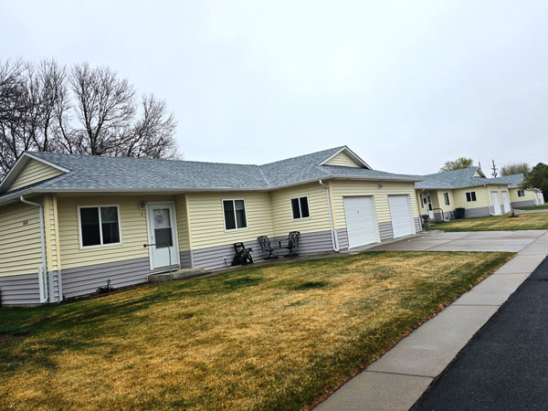 Replaced siding roofing and gutters in Brush Colorado Diligent Roofing Colorado After a hail storm damaged a townhome community Diligent Roofing replaced the roof gutters siding and windows on all the multi family units
